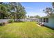 A sprawling backyard with mature palm trees, a shed and a seating area at 2275 Clematis St, Sarasota, FL 34239