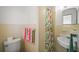 Cozy bathroom featuring yellow tiling and a colorful shower curtain at 2275 Clematis St, Sarasota, FL 34239