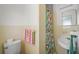Cozy bathroom featuring yellow tiling and a colorful shower curtain at 2275 Clematis St, Sarasota, FL 34239