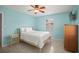 A sunlit bedroom with a ceiling fan, two windows, and neutral toned walls at 2275 Clematis St, Sarasota, FL 34239