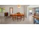 Dining room featuring wood table, terrazzo flooring, and natural light from an entry doorway at 2275 Clematis St, Sarasota, FL 34239