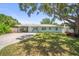 Charming single-story home with a well-manicured lawn and mature trees at 2275 Clematis St, Sarasota, FL 34239