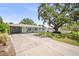 Inviting single-story home with a spacious driveway and lush green lawn at 2275 Clematis St, Sarasota, FL 34239