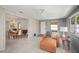 Bright sunroom featuring casual seating, neutral tones, and access to the dining room at 2275 Clematis St, Sarasota, FL 34239