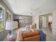 Relaxing sunroom offers comfortable seating, ceiling fan, and views of the landscaped yard at 2275 Clematis St, Sarasota, FL 34239
