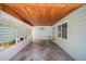 Covered patio with a wooden ceiling, lattice accents, concrete floor, and an exterior window at 2275 Clematis St, Sarasota, FL 34239