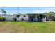 Well-maintained backyard featuring a patio and ample green space for outdoor activities and relaxation at 320 59Th W St, Bradenton, FL 34209