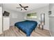 Comfortable bedroom featuring a ceiling fan, natural light, and stylish flooring at 320 59Th W St, Bradenton, FL 34209