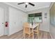 Dining area with a ceiling fan, wooden table, four chairs, and a bank of built-in storage at 320 59Th W St, Bradenton, FL 34209