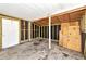 Unfinished garage area, with stud framing, and a fire extinguisher hanging by the door at 320 59Th W St, Bradenton, FL 34209
