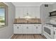 A well-lit kitchen area featuring bright white cabinetry and stainless steel appliances at 320 59Th W St, Bradenton, FL 34209