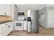Bright kitchen with stainless steel refrigerator, white cabinets, and modern appliances at 320 59Th W St, Bradenton, FL 34209