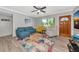 Comfortable living room with a colorful rug, a ceiling fan, and a view to the outside at 320 59Th W St, Bradenton, FL 34209