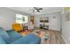 Cozy living room featuring modern furniture, wood-look flooring and a ceiling fan at 320 59Th W St, Bradenton, FL 34209