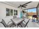 Relaxing screened patio featuring a ceiling fan, seating, and outdoor grill for entertaining at 320 59Th W St, Bradenton, FL 34209