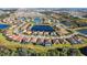 Aerial view of houses surrounding pond in an upscale community with well-manicured lawns and landscaping at 3218 Big Sky Way, Bradenton, FL 34211