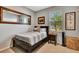 Cozy bedroom with neutral walls, wood furniture, and natural light from the window at 3218 Big Sky Way, Bradenton, FL 34211