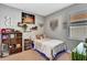 Bedroom with decorative tapestries, shelving, and large window at 3218 Big Sky Way, Bradenton, FL 34211