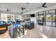 Open social area with wicker couches, tile floor, ceiling fans, and doors to a covered patio at 3218 Big Sky Way, Bradenton, FL 34211