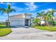 Beautiful one-story home with tile roof, paver driveway, tropical landscaping, and a two-car garage at 3218 Big Sky Way, Bradenton, FL 34211