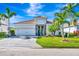Charming home with lush landscaping, paver driveway, tile roof, and two-car garage at 3218 Big Sky Way, Bradenton, FL 34211
