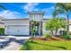 Charming single-story home with a well-manicured lawn and colorful landscaping, showcasing curb appeal at 3218 Big Sky Way, Bradenton, FL 34211