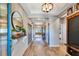Well-lit hallway features wood floors, tray ceiling, and stylish decor at 3218 Big Sky Way, Bradenton, FL 34211