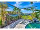 Backyard pool area with covered hammock and lake view at 3218 Big Sky Way, Bradenton, FL 34211