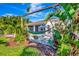 Relaxing hammock area outside of the back porch, surrounded by lush tropical foliage at 3218 Big Sky Way, Bradenton, FL 34211