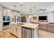 Modern kitchen with granite island, stainless steel appliances, and open floor plan at 3218 Big Sky Way, Bradenton, FL 34211