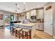 Stylish kitchen features a large island, white cabinets, and modern lighting fixtures at 3218 Big Sky Way, Bradenton, FL 34211