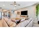 Spacious living room with neutral colors, ceiling fan, and view into kitchen at 3218 Big Sky Way, Bradenton, FL 34211