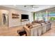 Bright living room boasts large windows, stylish furnishings, and modern decor at 3218 Big Sky Way, Bradenton, FL 34211