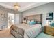 Relaxing primary bedroom boasts neutral tones, accent lighting, and en suite bath access at 3218 Big Sky Way, Bradenton, FL 34211
