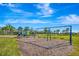 Community playground and swings in a lush green park setting with bright blue skies at 3218 Big Sky Way, Bradenton, FL 34211