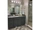 Bathroom vanity with granite countertop, gray cabinets, and modern fixtures near walk-in shower at 3418 79Th Street W Cir # 202, Bradenton, FL 34209