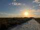 Sandy beach path leading to the shore at sunset at 3418 79Th Street W Cir # 202, Bradenton, FL 34209