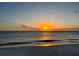 Scenic beach sunset with birds soaring above tranquil waters at 3418 79Th Street W Cir # 202, Bradenton, FL 34209