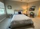 Bedroom features a comfortable bed, soft lighting, and neutral decor with a ceiling fan at 3418 79Th Street W Cir # 202, Bradenton, FL 34209