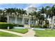 Inviting clubhouse with tropical landscaping, palm trees, and a welcoming entrance at 3418 79Th Street W Cir # 202, Bradenton, FL 34209