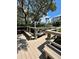 Outdoor deck with benches surrounded by lush greenery and mature trees at 3418 79Th Street W Cir # 202, Bradenton, FL 34209
