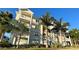 Beautiful building with balconies and stairs framed by palm trees on a sunny day at 3418 79Th Street W Cir # 202, Bradenton, FL 34209