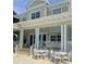 Beautiful exterior view of a multi-story building with white columns and outdoor seating at 3418 79Th Street W Cir # 202, Bradenton, FL 34209