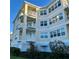 Multi-story building with large windows and multiple balconies, surrounded by greenery at 3418 79Th Street W Cir # 202, Bradenton, FL 34209