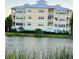 Back of complex beside the water in a well-kept community with colorful sky above at 3418 79Th Street W Cir # 202, Bradenton, FL 34209