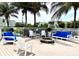 Outdoor entertaining with cozy firepit and comfortable seating beneath palm trees at 3418 79Th Street W Cir # 202, Bradenton, FL 34209