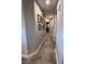 Long hallway with tile flooring, wall art, and recessed lighting, leading to other rooms at 3418 79Th Street W Cir # 202, Bradenton, FL 34209