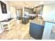 Open kitchen view with accent island, neutral colored cabinets and granite countertops at 3418 79Th Street W Cir # 202, Bradenton, FL 34209
