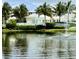 Scenic view of a pond with a fountain surrounded by well-maintained landscaping at 3418 79Th Street W Cir # 202, Bradenton, FL 34209