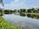 Scenic view of a pond with a fountain and condo buildings in the background at 3418 79Th Street W Cir # 202, Bradenton, FL 34209